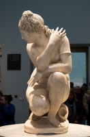 Marble statue of a naked Aphrodite crouching at her bath